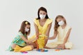 Language and foreign language learning. An English teacher conducts a masked lesson to two masked girls. Royalty Free Stock Photo