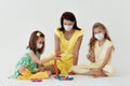 Language and foreign language learning. An English teacher conducts a masked lesson to two masked girls. Royalty Free Stock Photo