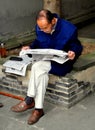 Langzhong, China: Elderly Man Reading Newspaper Royalty Free Stock Photo