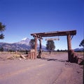 lanin national park with wooden entrance, dirt road and lanin sky blue volcano, neuqien province argentina