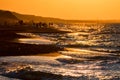 Beautiful sunset seashore landscape with people and mountains on background Royalty Free Stock Photo