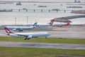 Cathay dragon`s passenger airplane is landing in runway, all parking space is fully