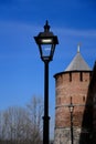 Lantern on the background of an ancient castle. LED lamppost on the background of the tower of the ancient city. Royalty Free Stock Photo