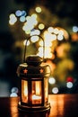 A lantern with a lit candle inside with bokeh lights on background Royalty Free Stock Photo
