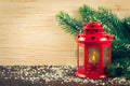 Lantern and Christmas tree over snow on wooden background Royalty Free Stock Photo