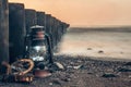 Lantern and compass rest on the pebbled shore of Wustrow, Germany Royalty Free Stock Photo