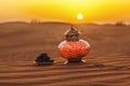 Lantern and dates in the desert at a beautiful sunset, symbolizing Ramadan