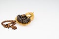 Lantern, Dates, Koran and Rosary on black and white background