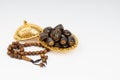 Lantern, Dates, Koran and Rosary on white background with selective focus and crop fragment