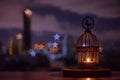 Lantern that have moon symbol on top with city bokeh light.