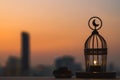 Lantern that have moon symbol on top and small plate of dates fruit