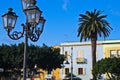 Lantern if front of colorful buildings at Carloforte harbor, San Pietro island, Sardinia Royalty Free Stock Photo