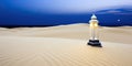 A lantern illuminating a serene desert landscape under a moonlit sky
