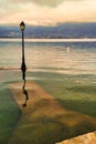 Lantern at jetty on lake annecy flooded because of high water level