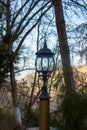 Old lantern in the park on landscape background Royalty Free Stock Photo