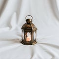 Lantern rests on a soft, white fabric backdrop, enhancing its intricate Royalty Free Stock Photo