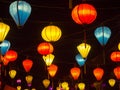 Lantern seller in the streets of ancient town of Hoi An in Central Vietnam, colorful lanterns hanging everywhere creating a great