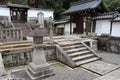 A lantern and stone steles decorate the courtyard of a temple (Japan)