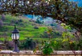 Lantern on a stone wall underneath a hedge arch Royalty Free Stock Photo