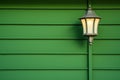 a lantern style porch light against a green, painted wall