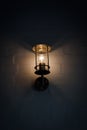 Lantern at wall illuminating darkness Royalty Free Stock Photo