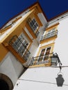 LANTERN AND WINDOWS ON WHITE YELLOW FACADE, EVORA, PORTUGAL Royalty Free Stock Photo