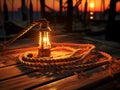 Lantern on a wooden pier at sunset, close-up.