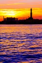 Sunset at Genoa`s port, silhouette of the Lanterna, Italy Royalty Free Stock Photo