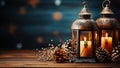 Lanterns with candles next to pine cones on dark wooden surface. Elegant festive background for design with copy spase