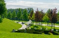 Lanterns in form of dandelions in park`s alleys and comfortable wooden sun loungers for relax. Public landscape city park