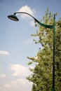 Lanterns in the park against the sky and trees. Blue sky with white clouds Royalty Free Stock Photo