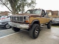 Old brown 1980s Ford Ranger XLT 4x4 off road lifted pickup truck. AAA 2022 classic car show.