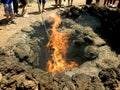 Lanzarote island Spain fire coming out of a small crater in volcanic terrain, from which tourist visits are made and barbecues are