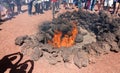 LANZAROTE, SPAIN - APRIL 20, 2018: Unrecognizable tourists watching and taking photos of fire demonstration in Timanfaya volcanic