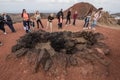 Tourist watching fire demonstration in Timanfaya volcanic national park in Lanzarote, Canary islands, Spain.