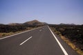 Lanzarote - Timanfaya NP: Driving trip on endless empty asphalt road between black lava rocks in barren landscape