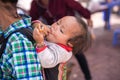 Lao Cai, Vietnam - Sep 7, 2017: Ethnic minority child on her mother back at local market in Y Ty, Bat Xat district