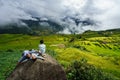 Lao Cai, Vietnam - Sep 7, 2017: Terraced rice field on harvesting season with children sitting on rock in Y Ty, Bat Xat district