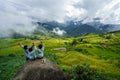 Lao Cai, Vietnam - Sep 7, 2017: Terraced rice field on harvesting season with children sitting on rock in Y Ty, Bat Xat district