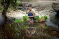 Lao woman Vientiane, Laos, is cleaning riverside vegetables. Royalty Free Stock Photo