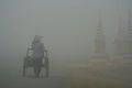 Lao woman walking in fog Royalty Free Stock Photo