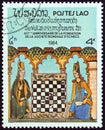 LAOS - CIRCA 1984: A stamp printed in Laos shows Two women playing illustration from King Alfonso X`s Book of Chess, circa 1984.