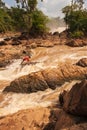 Laos fisherman in rapids of Khone Phapheng Falls on the Mekong River. The Khone Phapheng Falls are the largest in southeast asia.