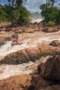 Laos fishermen in rapids of Khone Phapheng Falls on the Mekong River. The Khone Phapheng Falls are the largest in southeast asia.