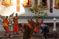 Laos: Monks as construction workers in Luang Brabang