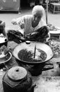 Laos: A old woman coocking fresh fish soup on the market in Luang Brabang Royalty Free Stock Photo