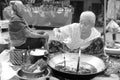 Laos: A old woman coocking fresh fish soup on the market in Luang Brabang Royalty Free Stock Photo