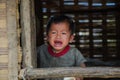 A Laotian baby crying at the window of his traditional home Royalty Free Stock Photo