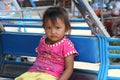 Portrait of an illiterate Laotian girl in a tuktuk, Pakse, Laos