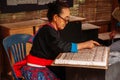 Laotian Senior woman do Batik fabric painting